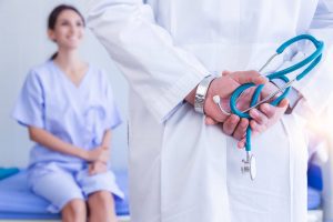Doctor with stethoscope consults with female patient