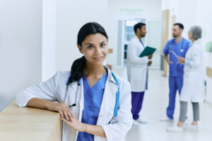 Female physician standing with stethoscope in the hallway of a modern hospital 