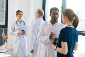 Diverse group of multi-ethnic male and female doctors having a conversation in a clinic