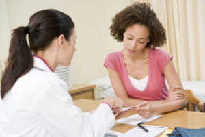 Woman having consultation with female physician